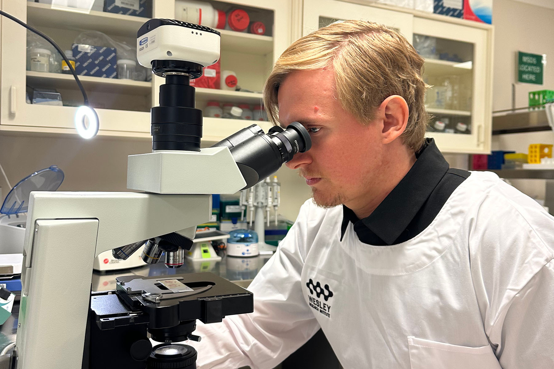 Biobank staff using microscope