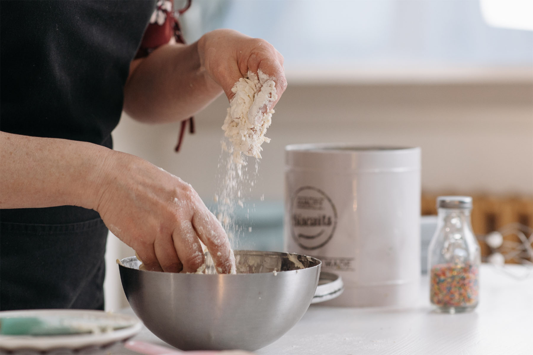 A person mixing baking ingredients in a bowl
