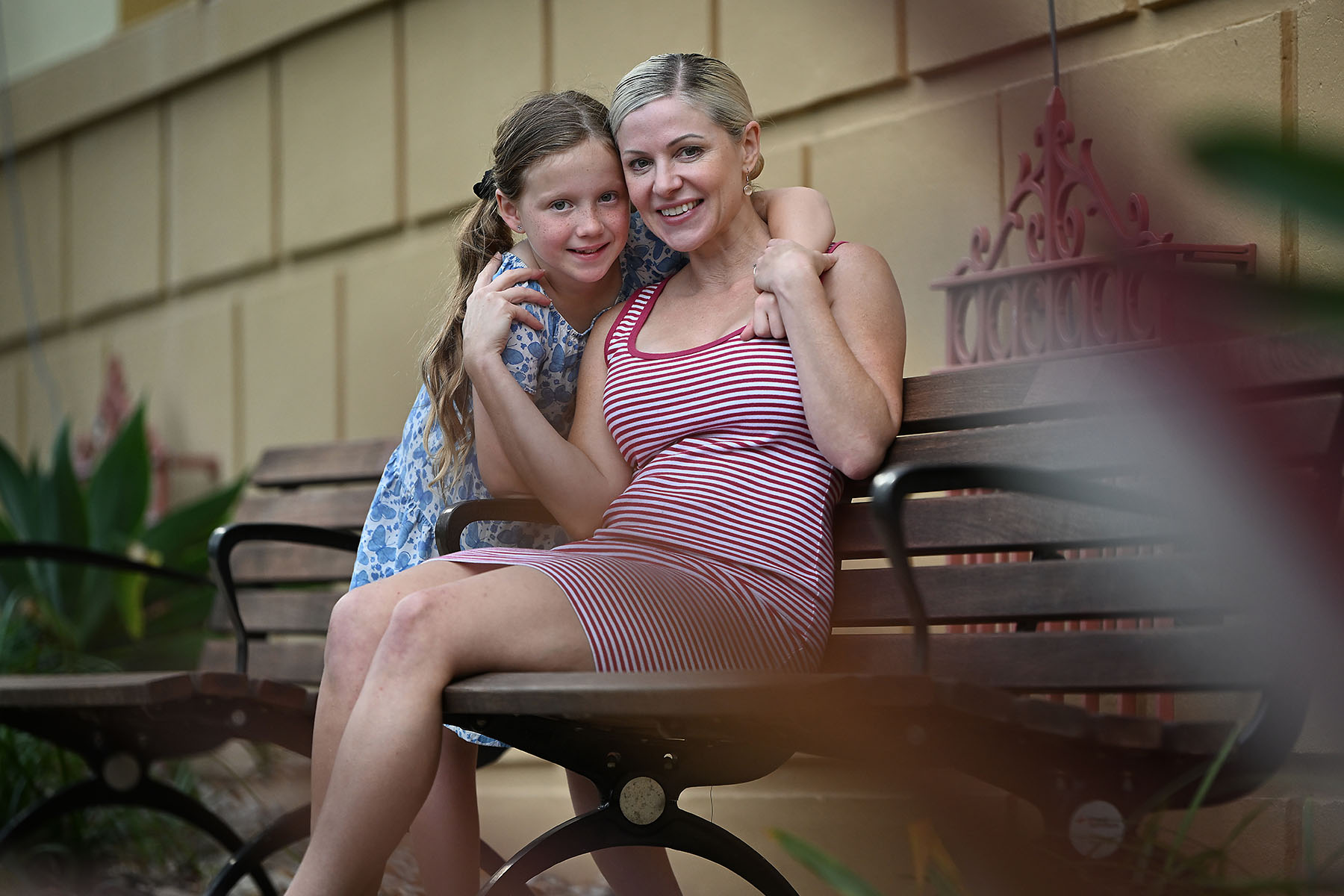 Kristina sitting with her daughter on a bench